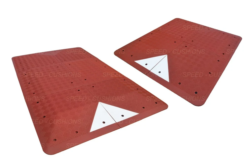 Red and white UK speed cushions to reduce vehicles' speed.