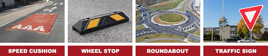 A red rubber speed cushion, a black rubber wheel stop with yellow reflective films, a roundabout, and a triangle traffic sign.
