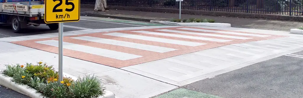 Red and white raised pedestrian crossings.