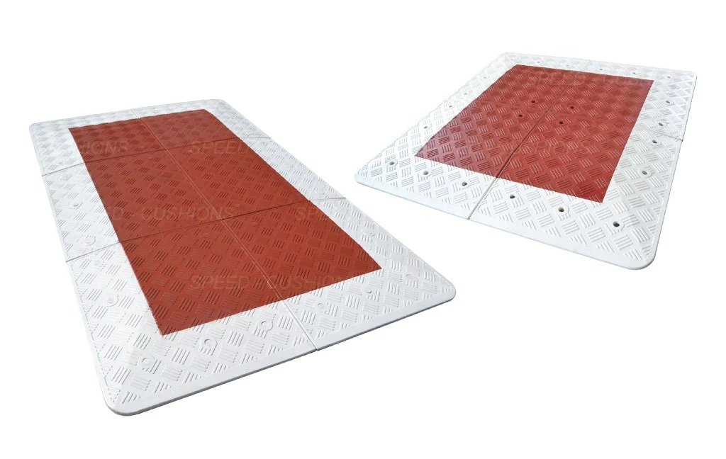 Red and white Belgium speed cushions for traffic-calming purposes.