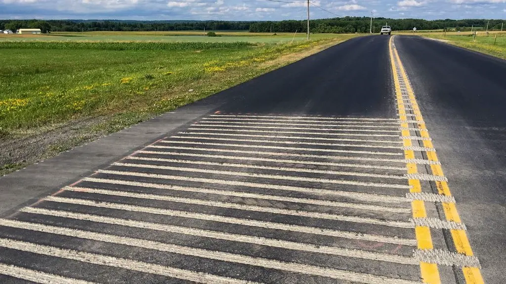 Rumble strips on the road for traffic-calming purposes.